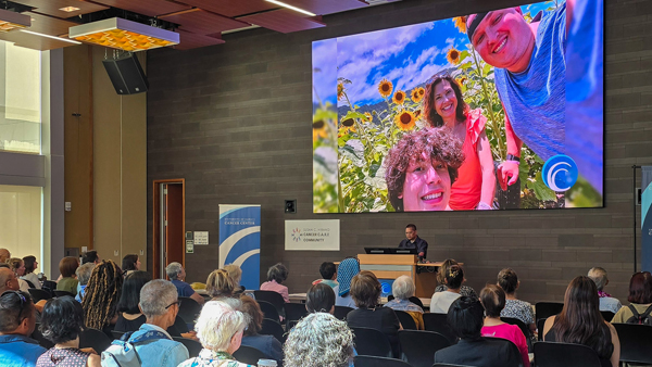 Event attendees watching commemorative video